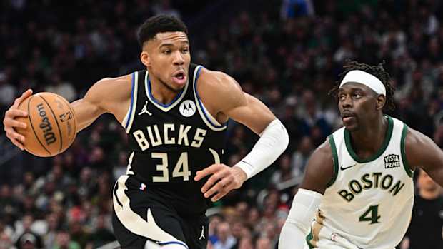 Milwaukee Bucks star Giannis Antetotkounmpo drives against Boston Celtics guard Jrue Holiday